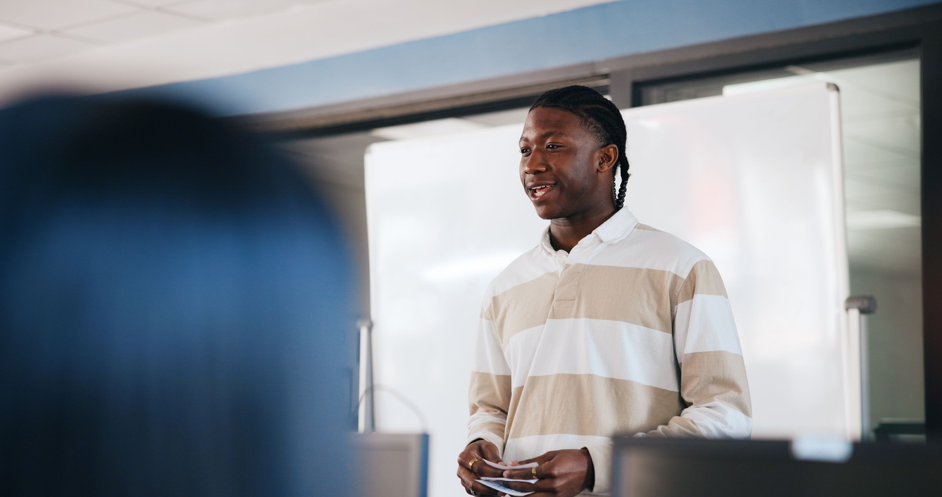 Black man, student and presentation with whiteboard for learning, moderation or education at university. African learner, assessment or introduction with notes or cue cards for oral speech at college